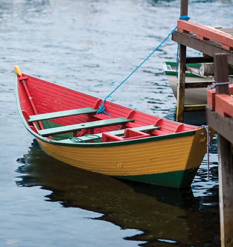 A small boat attached to a wharf