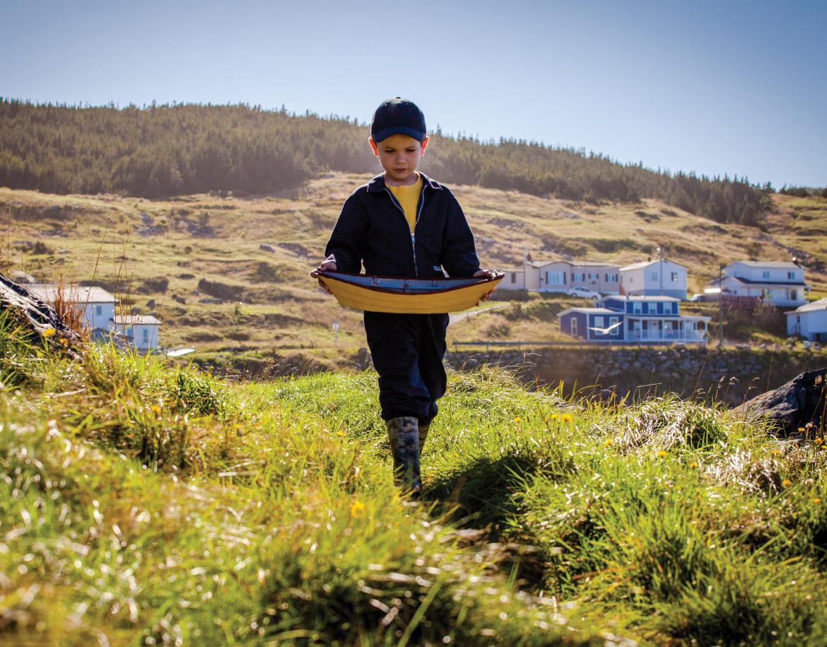 Young boy holding a toy dory as he walks through Winterton