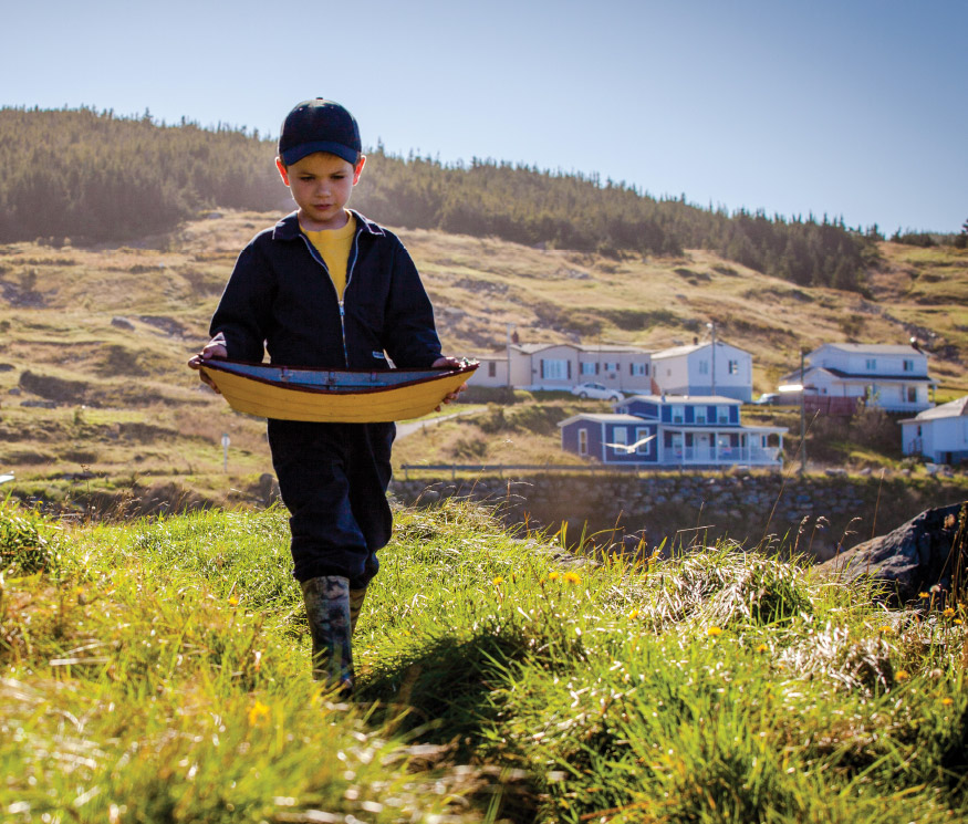 Young boy holding a toy dory as he walks through Winterton